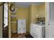 Functional laundry room with washer, dryer, storage cabinet, and shelving at 222 Sinclair Rd, Summerville, SC 29483