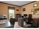 Well-lit home office with desk, bookcase, and window offering a view of nature at 222 Sinclair Rd, Summerville, SC 29483
