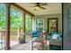 Relaxing porch with comfortable seating, ceiling fan, and view of the green landscape at 222 Sinclair Rd, Summerville, SC 29483
