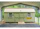 View of the storage shed under the carport with a metal roof, and double doors at 222 Sinclair Rd, Summerville, SC 29483
