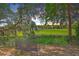 Inviting backyard with a wrought iron bench overlooking lush green marsh at 2340 Ashley River Rd, Charleston, SC 29414