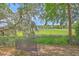 Inviting backyard with a wrought iron bench overlooking lush green marsh at 2340 Ashley River Rd, Charleston, SC 29414