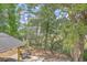 View of a backyard patio area surrounded by mature trees at 2340 Ashley River Rd, Charleston, SC 29414