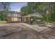 Rear view of brick home with outdoor seating area, carport and porch at 2340 Ashley River Rd, Charleston, SC 29414