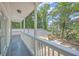 Relaxing balcony view overlooking lush trees and a backyard patio at 2340 Ashley River Rd, Charleston, SC 29414