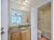 Bathroom with granite countertop, vanity, and combination tub and shower at 2340 Ashley River Rd, Charleston, SC 29414