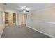 This bonus room is carpeted and features a built-in bookcase and a ceiling fan at 2340 Ashley River Rd, Charleston, SC 29414