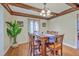 Dining room with exposed wood beam ceiling, hardwood floors, and traditional wooden furniture at 2340 Ashley River Rd, Charleston, SC 29414