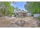 A brick home with a covered patio area and a fire pit at 2340 Ashley River Rd, Charleston, SC 29414