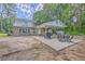 Exterior view of a brick home with an outdoor patio and two-story porch at 2340 Ashley River Rd, Charleston, SC 29414