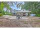Brick home with a covered patio and landscaped backyard at 2340 Ashley River Rd, Charleston, SC 29414