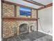 Close-up of brick fireplace with TV and slate flooring at 2340 Ashley River Rd, Charleston, SC 29414