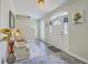 Welcoming foyer with slate tile, arched front door, staircase, and seating area creates a warm entry at 2340 Ashley River Rd, Charleston, SC 29414