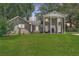 Classic brick home with prominent pillars and a well-manicured green lawn at 2340 Ashley River Rd, Charleston, SC 29414