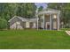 Classic brick home with prominent pillars and a well-manicured green lawn at 2340 Ashley River Rd, Charleston, SC 29414