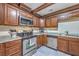 Close-up of updated kitchen with wood cabinets, stainless steel appliances, and granite countertops at 2340 Ashley River Rd, Charleston, SC 29414