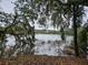 Waterfront with trees with Spanish moss. Home in background at 2340 Ashley River Rd, Charleston, SC 29414
