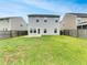 This property has a grassy backyard and a 2-story home in the background at 242 Daniels Creek Cir, Goose Creek, SC 29445