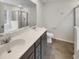 Bathroom with double sink vanity, walk-in shower and bright vanity lighting at 242 Daniels Creek Cir, Goose Creek, SC 29445