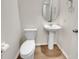 This bathroom features a toilet, sink, and a round mirror above the sink at 242 Daniels Creek Cir, Goose Creek, SC 29445