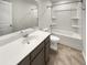 This bathroom features a vanity with a mirror and a shower-tub combo at 242 Daniels Creek Cir, Goose Creek, SC 29445