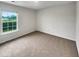 This bedroom features a light colored carpet and a window with green outdoor view at 242 Daniels Creek Cir, Goose Creek, SC 29445