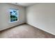 This bedroom features a light colored carpet and a window with blue home view at 242 Daniels Creek Cir, Goose Creek, SC 29445