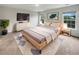 Beautifully staged bedroom with area rug, TV, windows and side tables at 242 Daniels Creek Cir, Goose Creek, SC 29445