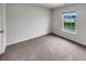 This bedroom features a light colored carpet and a window with blue home view at 242 Daniels Creek Cir, Goose Creek, SC 29445