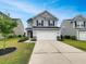 Charming two-story home with a well-manicured lawn and a two-car garage at 242 Daniels Creek Cir, Goose Creek, SC 29445