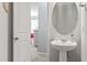 Chic half bathroom with a pedestal sink and modern fixtures at 2488 Stadium Dr, North Charleston, SC 29406