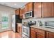 Modern kitchen boasts stainless steel appliances and hardwood floors for easy maintenance at 2488 Stadium Dr, North Charleston, SC 29406