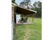 The back porch offers an outdoor dining space with a ceiling fan and plenty of seating at 277 Carolina Cir, Walterboro, SC 29488