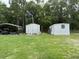 Exterior features a white mobile home, outbuilding, carport, and spacious yard perfect for outdoor activities at 277 Carolina Cir, Walterboro, SC 29488