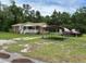 A brick single-story home with a covered porch and a metal carport beside it, set on a green lawn at 277 Carolina Cir, Walterboro, SC 29488