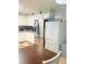 Well-lit kitchen with stainless steel appliances, white cabinets, two refrigerators, and a dark wood table at 277 Carolina Cir, Walterboro, SC 29488