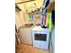 A laundry room featuring a Whirlpool washer and dryer set with storage shelves above at 277 Carolina Cir, Walterboro, SC 29488