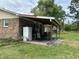 Back patio with brickwork on the house, plants and chairs set on a lush green lawn at 277 Carolina Cir, Walterboro, SC 29488