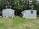 Backyard shed and trailer combination featuring a shed with double doors and a single wide trailer with a trimmed yard at 277 Carolina Cir, Walterboro, SC 29488