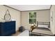 Stylish bedroom with a bed, a dresser, and a round mirror creating a modern and comfortable space at 282 Marion Rd, Dorchester, SC 29437