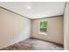 Bright bedroom with wood-look flooring and a view of the outdoors through a window at 282 Marion Rd, Dorchester, SC 29437