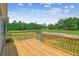 Lovely wooden deck with views of the backyard and black-painted wooden fence surrounding the property at 282 Marion Rd, Dorchester, SC 29437