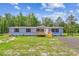 Charming single-story home with gray siding and black shutters surrounded by green grass and mature trees at 282 Marion Rd, Dorchester, SC 29437