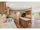 The kitchen with island has wood cabinets, granite countertops, and easy access to the dining and living areas at 282 Marion Rd, Dorchester, SC 29437