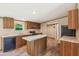 The functional kitchen features wood cabinets, granite countertops, and an island with an additional countertop space at 282 Marion Rd, Dorchester, SC 29437