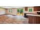 The open-concept living space features wood-look flooring, a sliding glass door, and kitchen with black appliances at 282 Marion Rd, Dorchester, SC 29437