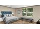 Serene main bedroom with a plush bed, a bench, and ample natural light from large windows at 282 Marion Rd, Dorchester, SC 29437