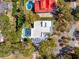 Aerial view of a property featuring a backyard pool, manicured lawn, and mature trees on a private lot at 3 Cross Ln, Isle of Palms, SC 29451
