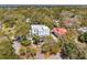 Expansive aerial view showcasing a luxury home with multi-level balconies and surrounded by lush, mature trees at 3 Cross Ln, Isle of Palms, SC 29451