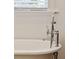 Close up of stylish chrome bathtub faucet with shower wand in bathroom at 3 Cross Ln, Isle of Palms, SC 29451
